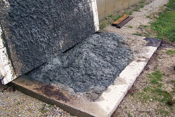 Foam spilling out from under a swine barn